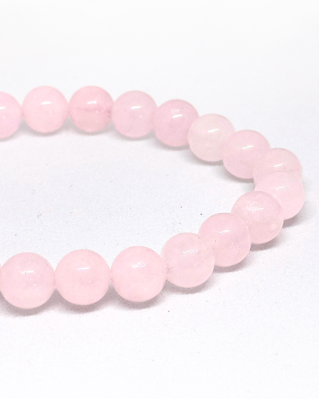 Pink beaded Rose Quartz bracelet on a white background