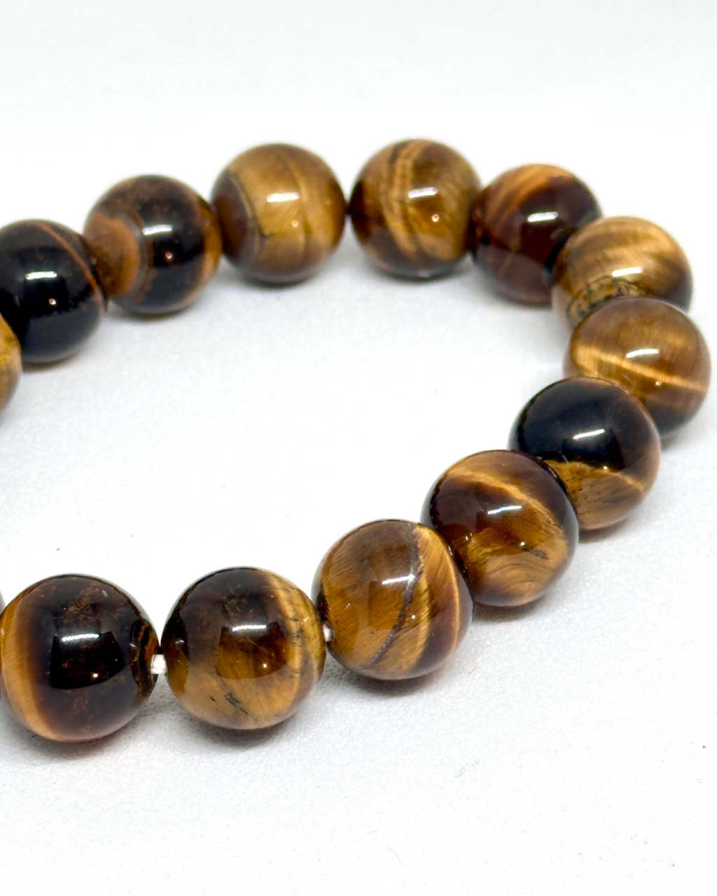Beaded bracelet with tiger eye stones 12mm on a white background