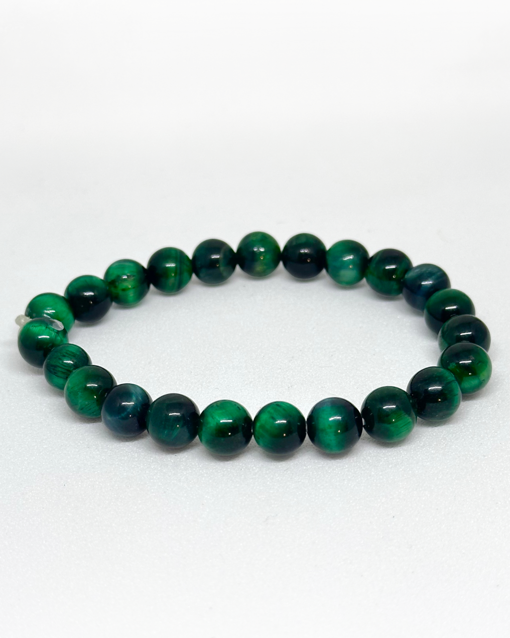 Green beaded Tiger-eye Bracelet on a white background