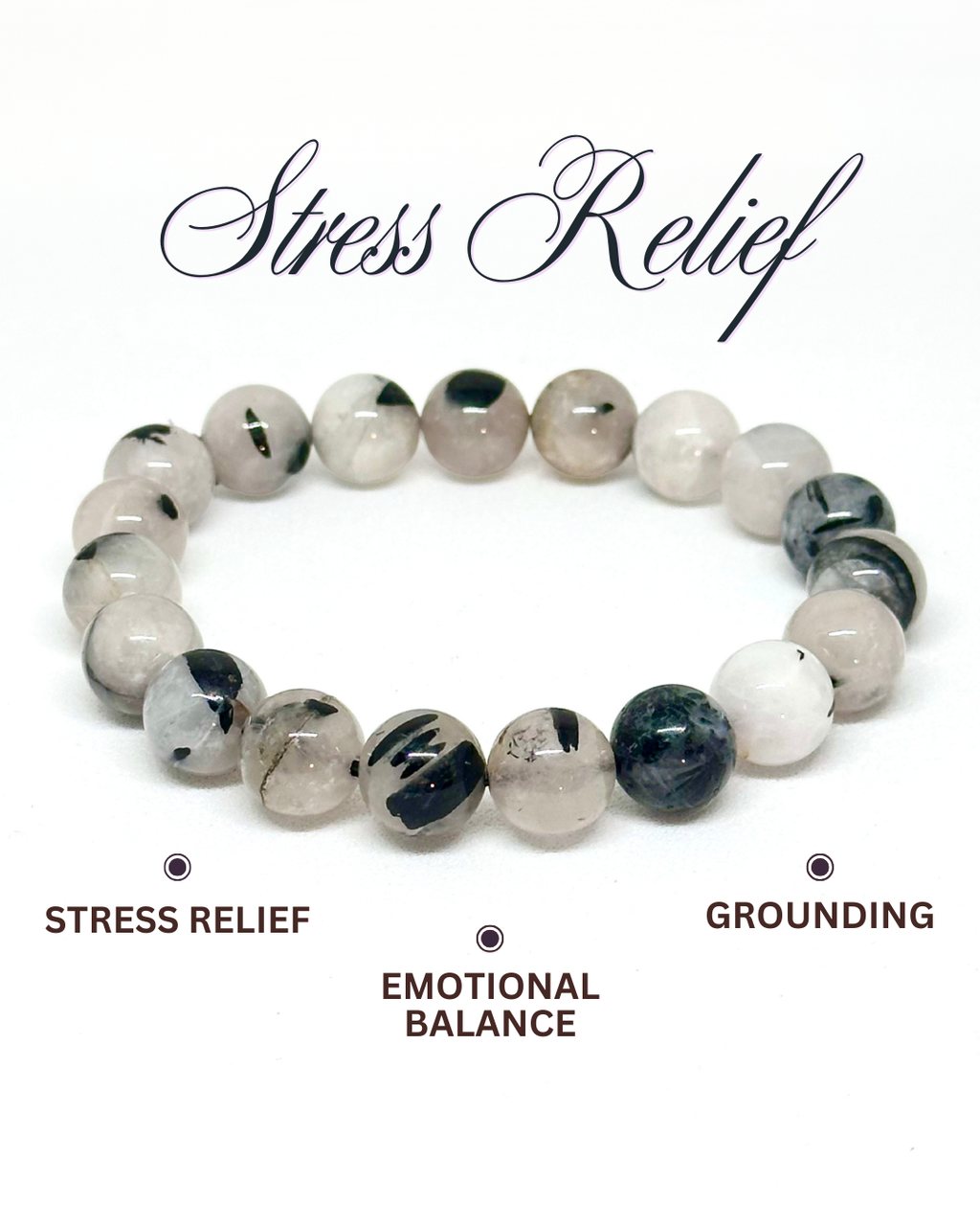 Beaded bracelet with black and white stones on a white background, labeled for stress relief and grounding. Black Rutilated Quartz Bracelet.